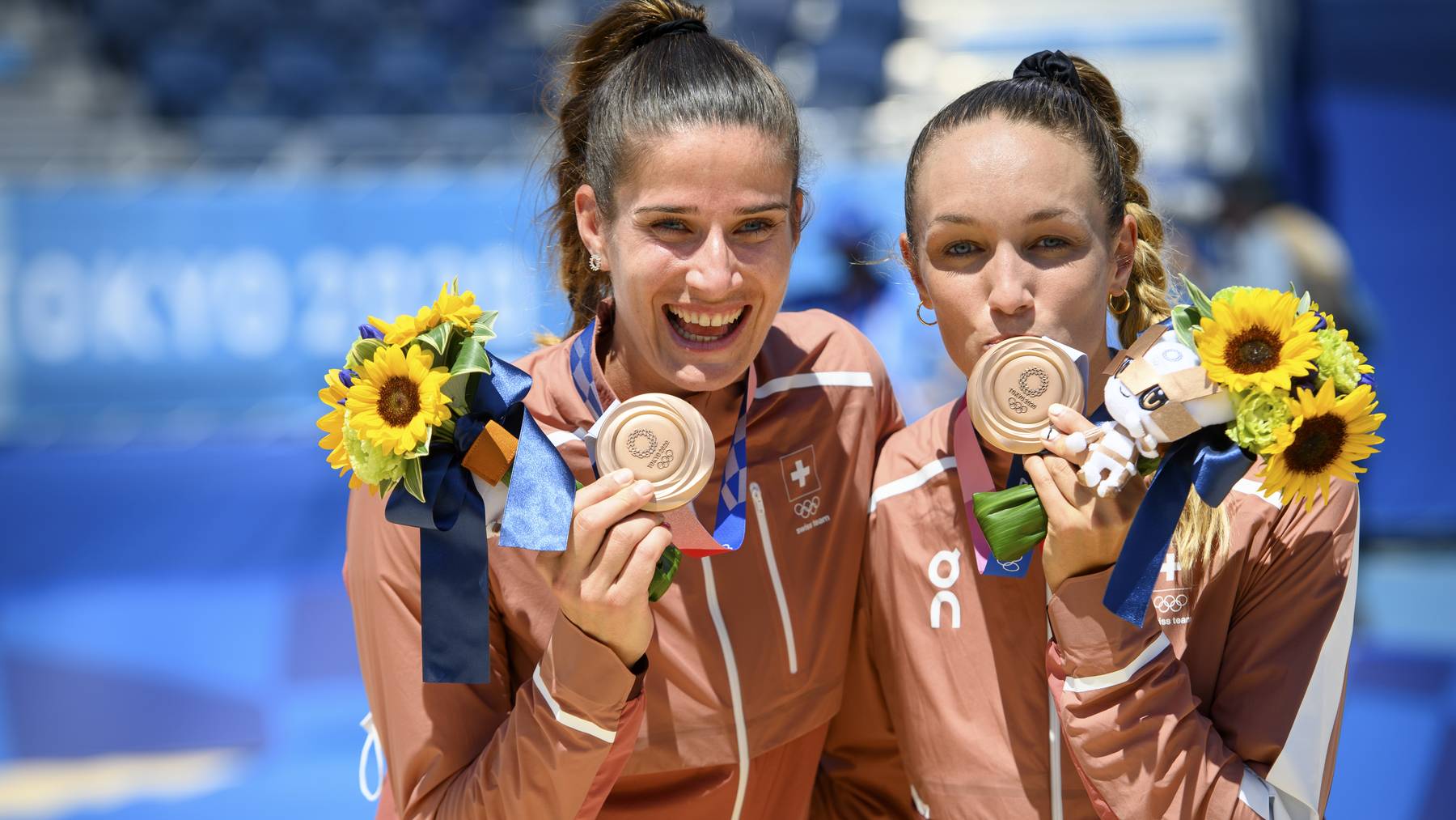 Bronze medal winner Anouk Verge-Depre, right, and Joana Heidrich, left, of Switzerland celebrate with they medal during the victory ceremony after the women's beach volleyball bronze medal game against Tina Graudina and Anastasija Kravcenoka of Latvia at the 2020 Tokyo Summer Olympics in Tokyo, Japan, on Friday, August 06, 2021