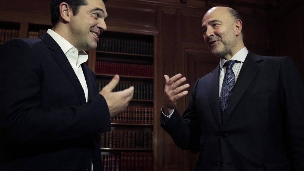 Alexis Tsipras (links) und Pierre Moscovici am Dienstag bei ihrem Treffen in Athen.