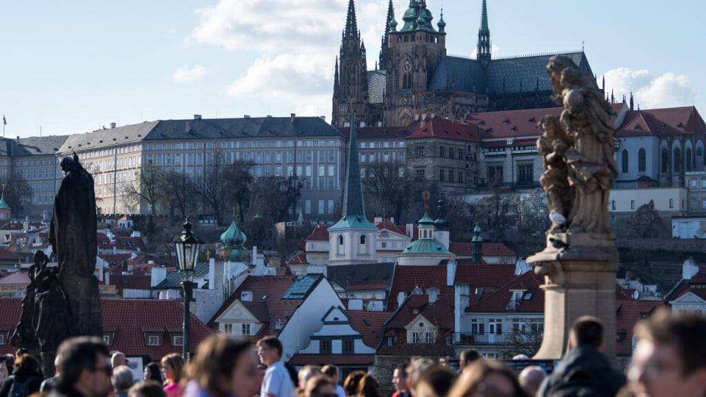 10.04.2018, Tschechien, Prag: Zahlreiche Touristen gehen über die Karlsbrücke. Im Hintergrund ist die Prager Burg zu sehen. Foto: Monika Skolimowska/dpa-Zentralbild/dpa