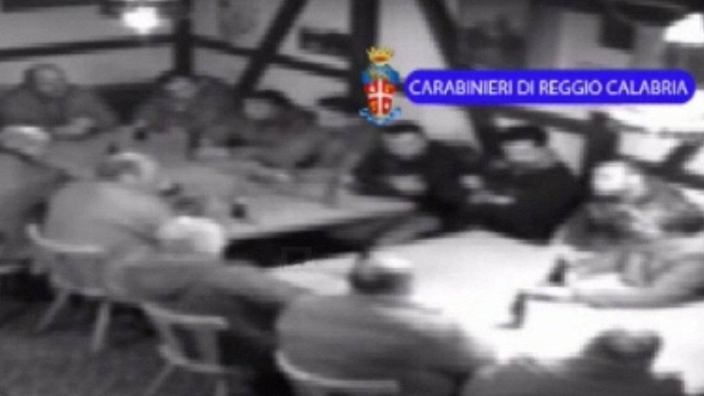 Eine Videosequenz der ''Operazione Helvetica" zeigt ein Dutzend Männer an zwei Tischen, vermutlich in einem Restaurant in der Schweiz. (Symbolbild)
