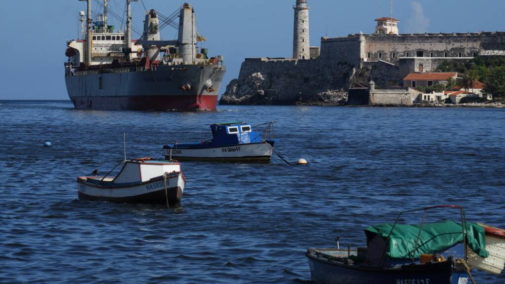 Das Frachtschiff Asian Katra (oben, l) kommt in der Bucht von Havanna an. Inmitten der schweren Versorgungskrise in Kuba ist eine Hilfslieferung aus Mexiko und Uruguay auf der sozialistischen Karibikinsel eingetroffen. Foto: Ramon Espinosa/AP/dpa