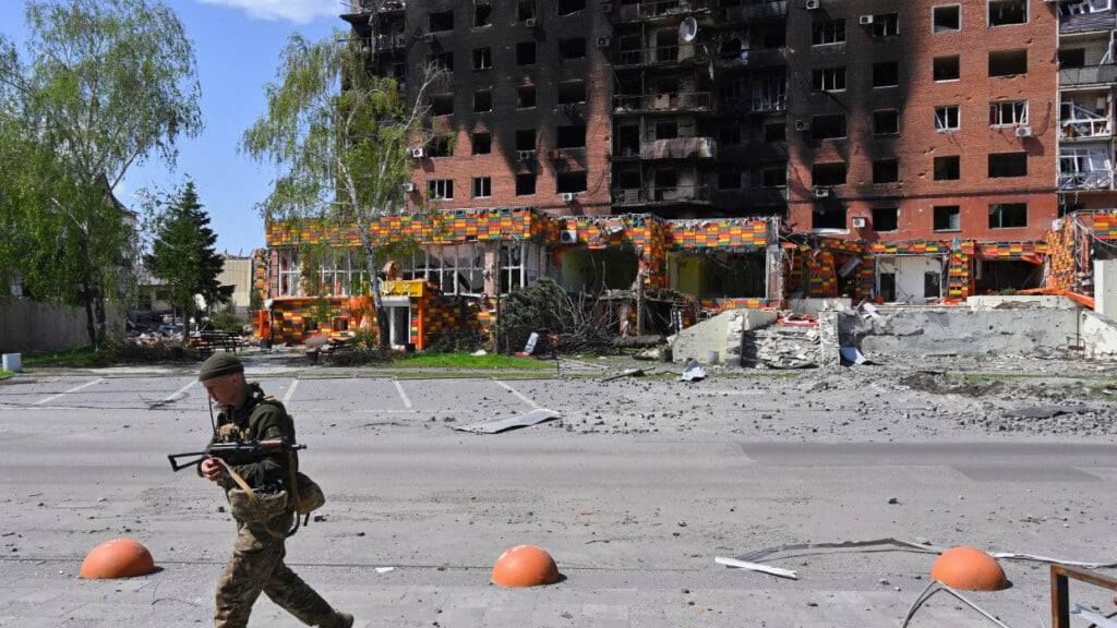 ARCHIV - Ein ukrainischer Soldat geht an beschädigten Gebäuden im Zentrum von Pokrowsk vorbei. Foto: Michael Shtekel/AP/dpa/Archivbild