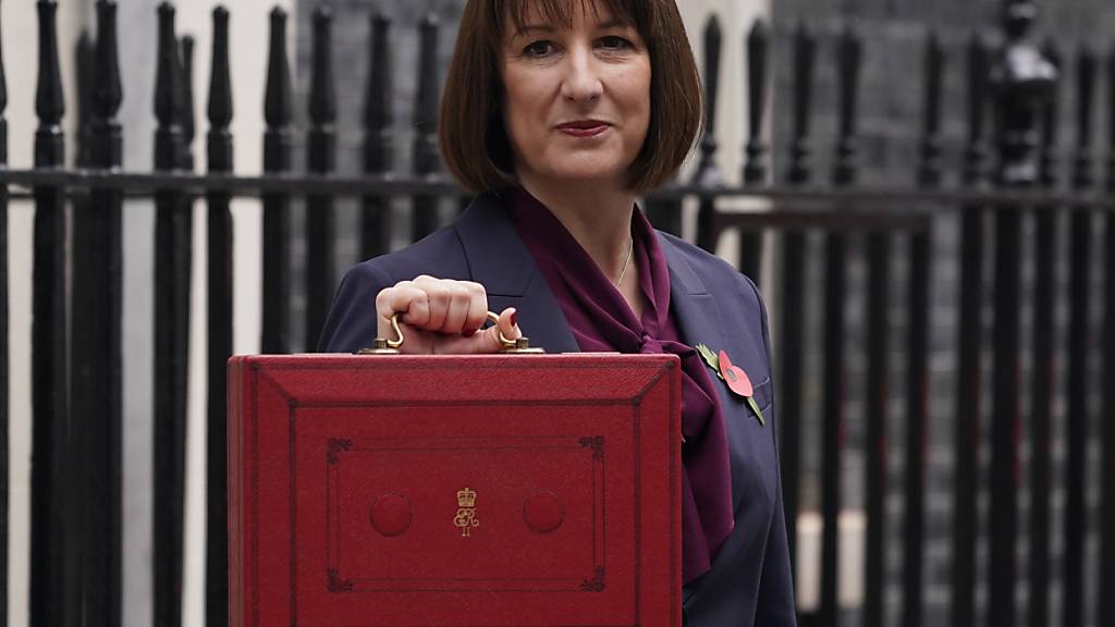 dpatopbilder - Die britische Finanzministerin Rachel Reeves hält die traditionelle rote Ministerbox mit ihrer Haushaltsrede hoch vor der Downing Street Nr. 11. Foto: Alberto Pezzali/AP