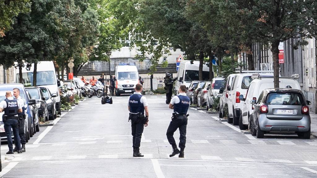 Zwei Polizisten stehen auf der Straße, wo der Lieferwagen gefunden wurde, der in eine Terrasse im Stadtzentrum gefahren ist und mehrere Personen leicht verletzt hat. Nach Angaben des Brüsselers Bürgermeisters Close könnten Zeugensausagen auf eine Straftat hindeuten. Foto: Juliette Bruynseels/BELGA/dpa