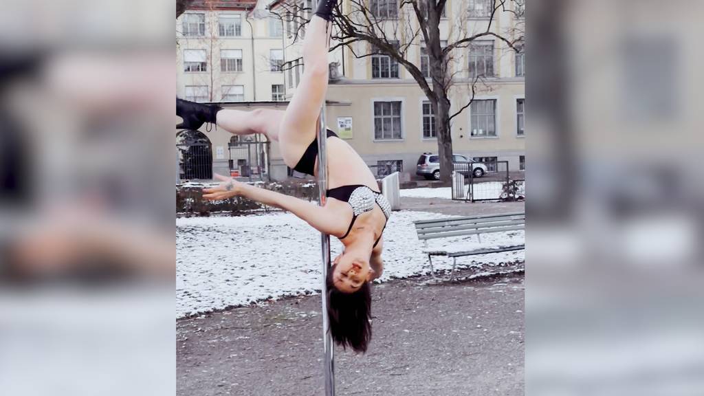 Pole Dancerin dreht sich mitten im verschneiten Zürich an der Stange