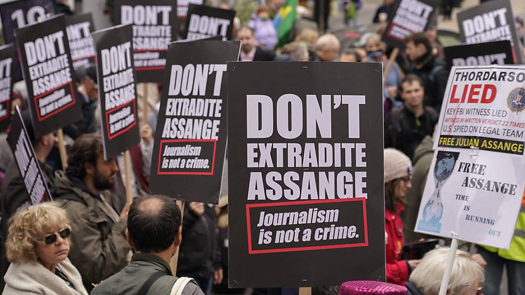 Unterstützer des inhaftierten Wikileaks-Gründers Assange halten während einer Demonstration Plakate in die Höhe. Die Menschenrechtsorganisation Amnesty International hat am Dienstag vor einer Anhörung im Fall Julian Assange erneut die Freilassung des Wikileaks-Gründers gefordert. Foto: Alberto Pezzali/AP/dpa
