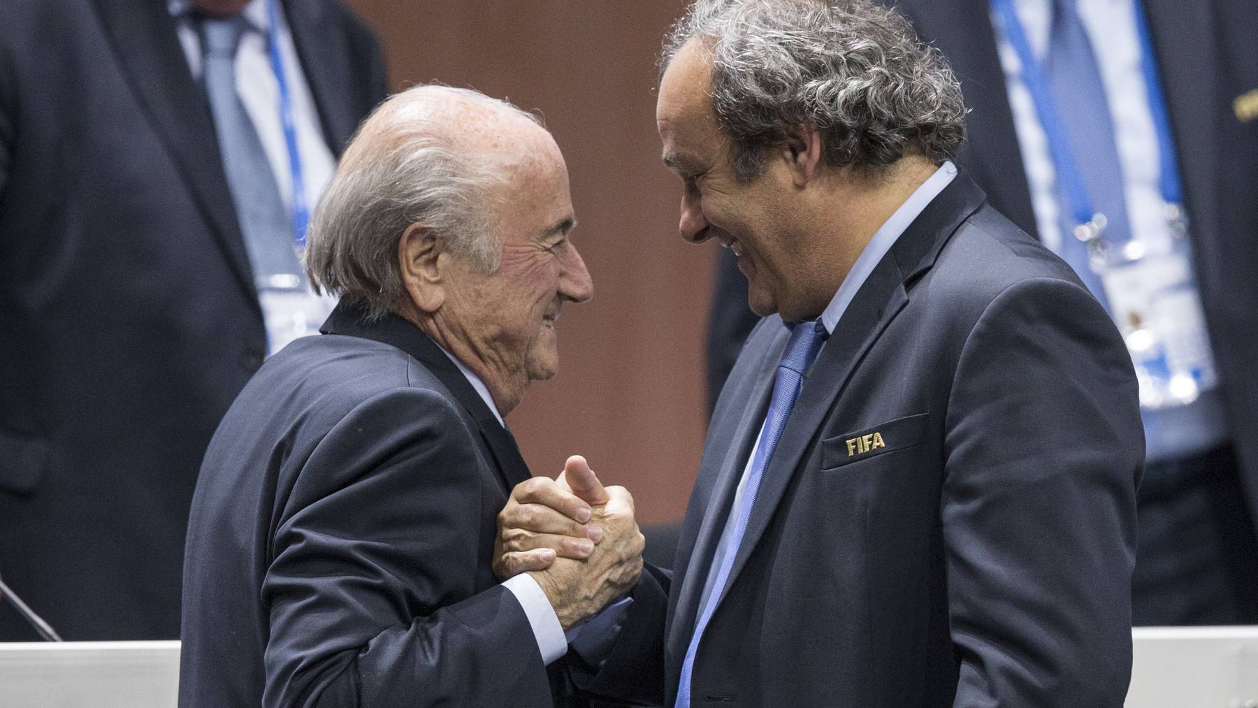 Re-elected FIFA president Joseph Sepp Blatter, left, is congratulated by FIFA vice president and UEFA president Michel Platini after his speech during the 65th FIFA Congress held at the Hallenstadion in Zurich, Switzerland, Friday, May 29, 2015. Blatter has been re-elected as FIFA president for a fifth term, chosen to lead world soccer despite separate U.S. and Swiss criminal investigations into corruption. The 209 FIFA member federations gave the 79-year-old Blatter another four-year term on Friday after Prince Ali bin al-Hussein of Jordan conceded defeat after losing 133-73 in the first round. (KEYSTONE/Patrick B. Kraemer)
