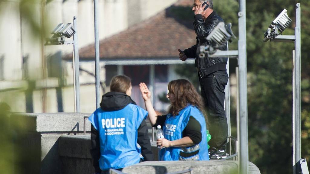 Zwei Polizistinnen und ein unidentifizierbarer Mann diskutieren am Donnerstag, 1. Oktober 2015, in Bern. Die Polizei hat einen Teil der Bundesterrasse gesperrt. (KEYSTONE/Lukas Lehmann)