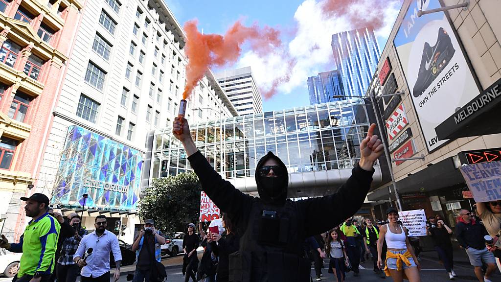 Protesters are seen during an anti-lockdown protest in the central business district of Melbourne, Saturday, August 21, 2021. (AAP Image/James Ross) NO ARCHIVING