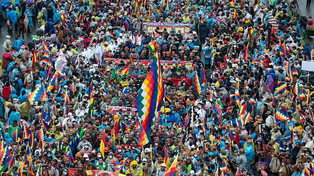 Zahlreiche Menschen schwenken Fahnen während einer Kundgebung in der Innenstadt von La Paz. Am Montag sind unter der Anführung von dem ehemaligen Präsidenten Evo Morales Tausende Menschen nach einem Marsch durch Bolivien in La Paz eingetroffen.