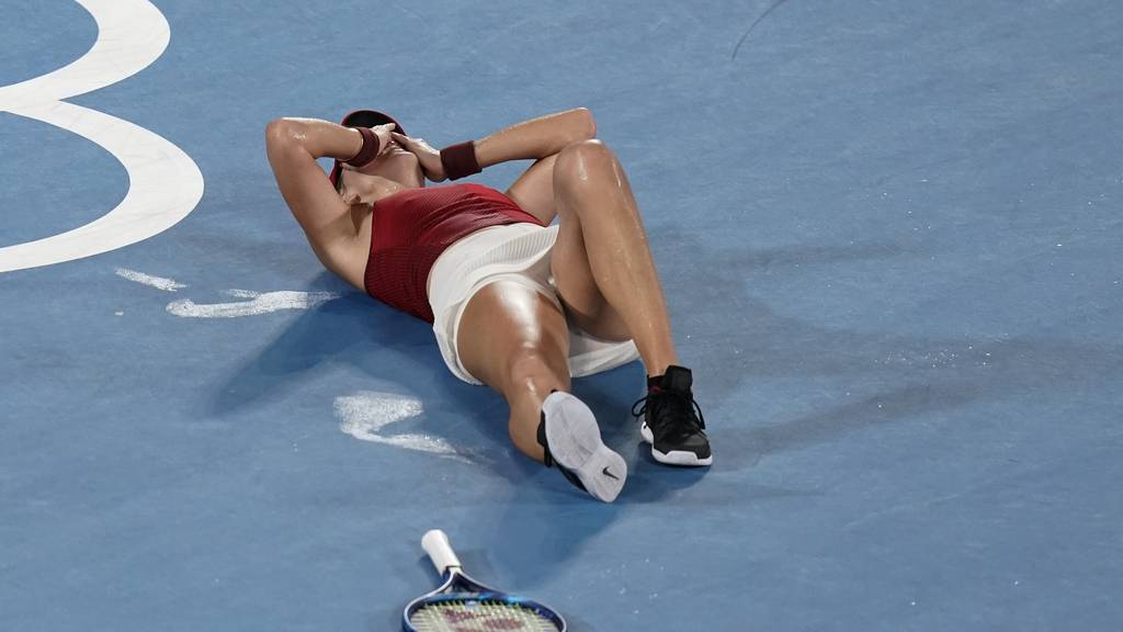 Belinda Bencic, of Switzerland, reacts after defeating Marketa Vondrousova, of the Czech Republic, in the women's gold medal match of the tennis competition at the 2020 Summer Olympics, Saturday, July 31, 2021, in Tokyo, Japan.