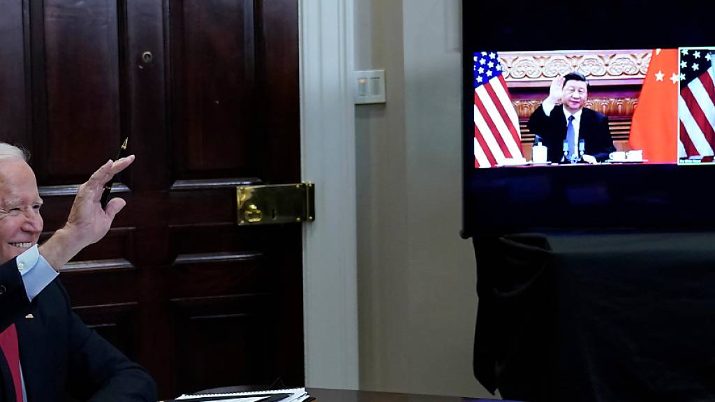 dpatopbilder - Joe Biden, Präsident der USA, (l) winkt Xi Jinping, Präsident von China, zur Begrüßung zu. Bei ihrem ersten Online-Gipfel am Dienstagmorgen (Ortszeit Peking) haben Joe Biden und Xi Jinping vor einer gefährlichen Konfrontation zwischen den beiden größten Volkswirtschaften gewarnt. Foto: Susan Walsh/AP/dpa